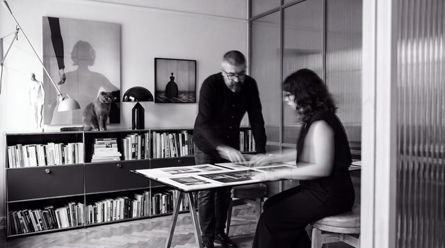 Umut at work with a collaborator, reviewing prints in the studio